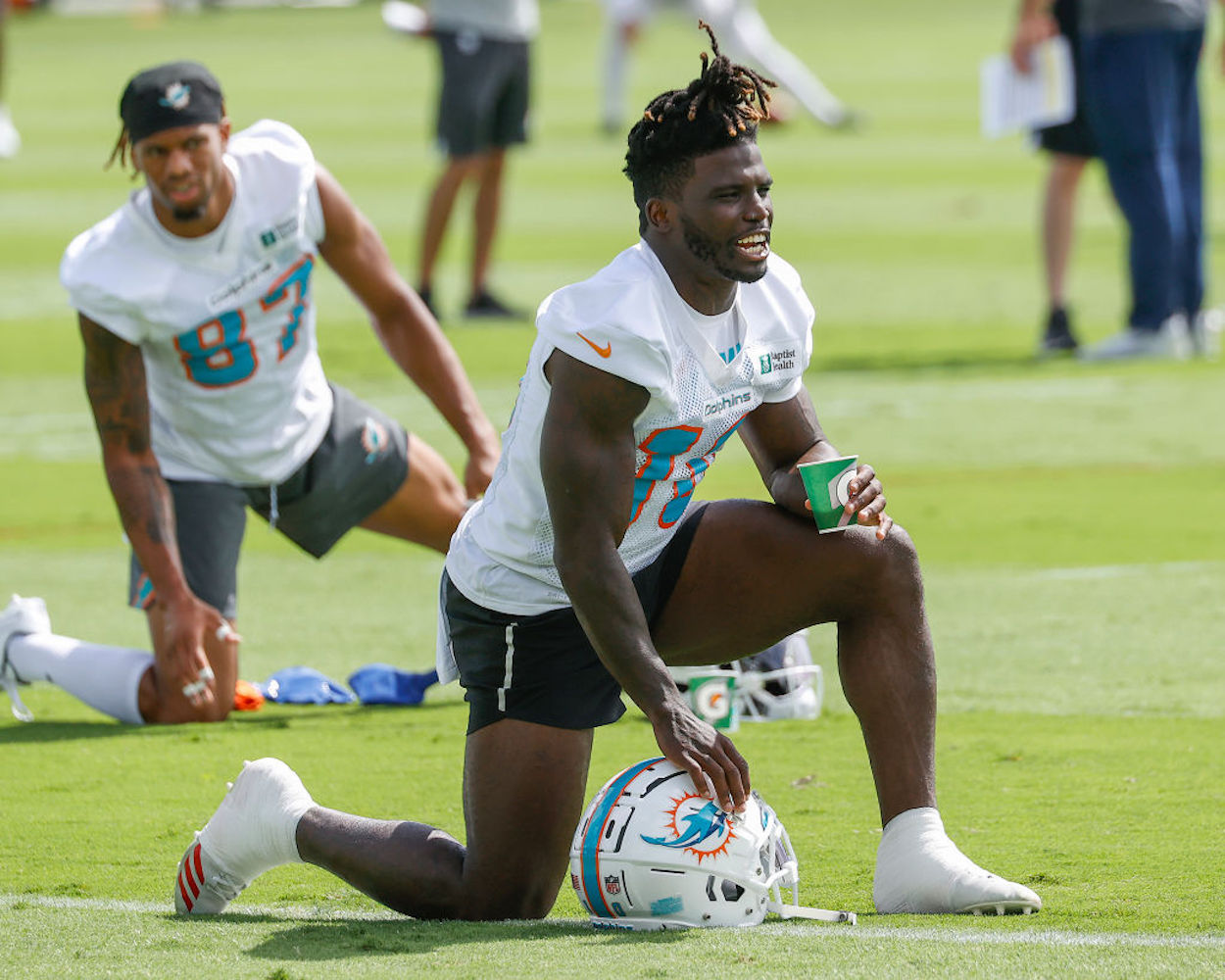 Tyreek Hill stretches at Miami Dolphins minicamp.