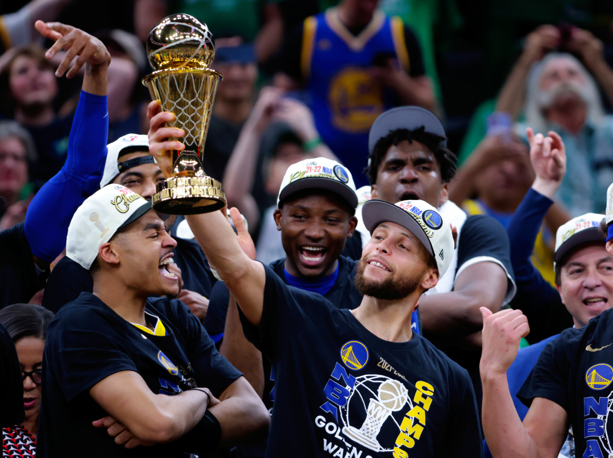 Golden State Warriors guard Stephen Curry lifts the Finals MVP trophy after they defeated the Boston Celtics 103-90.