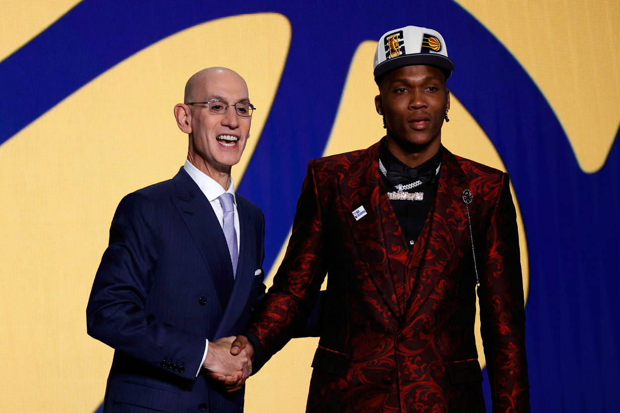 NBA Commissioner Adam Silver (L) and Bennedict Mathurin pose for photos.