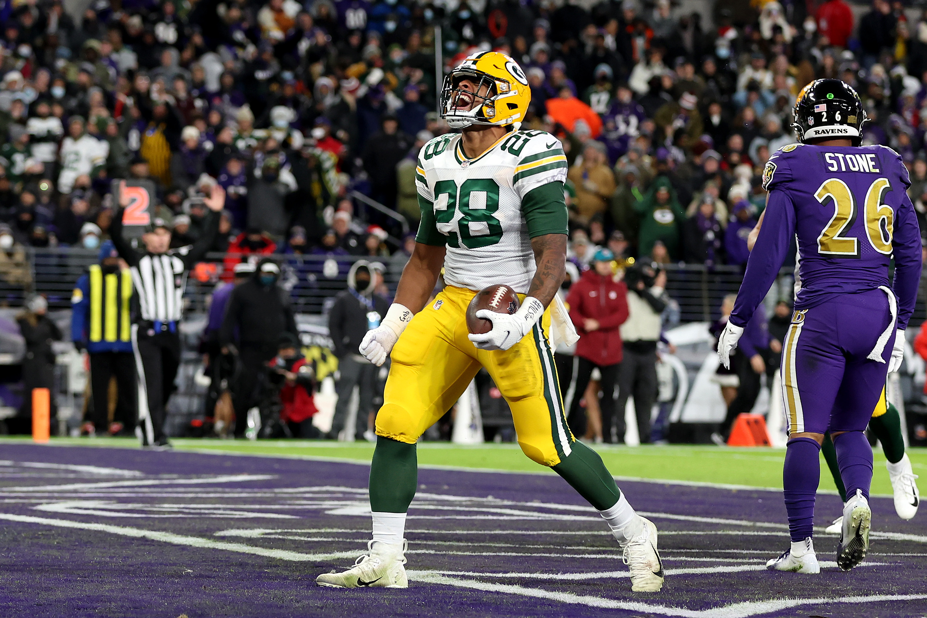 AJ Dillon of the Green Bay Packers reacts after scoring a rushing touchdown against the Baltimore Ravens.