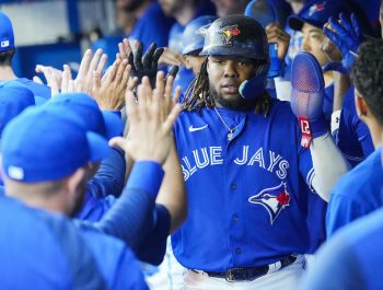 The Blue Jays celebrate in the dugout.