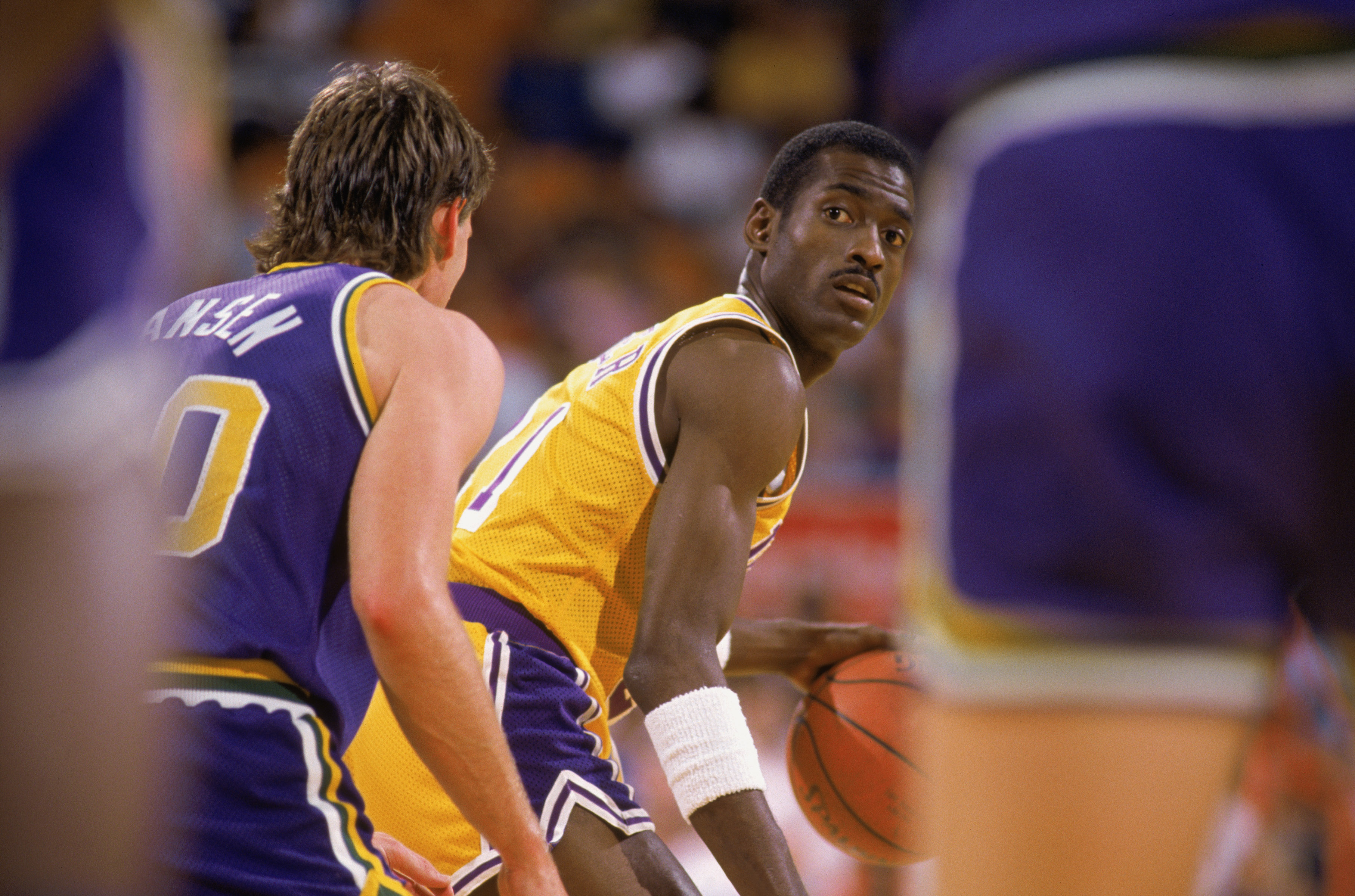 Michael Cooper of the Los Angeles Lakers dribbles the ball.