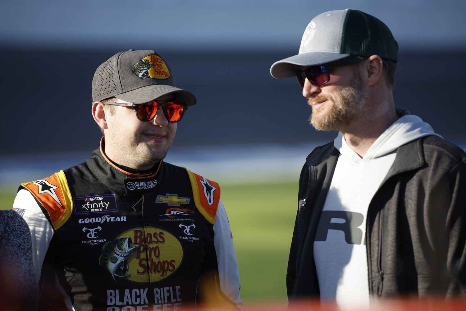 Noah Gragson and NASCAR Hall of Famer Dale Earnhardt Jr. talk on the grid at Daytona International Speedway on Feb. 19, 2022.