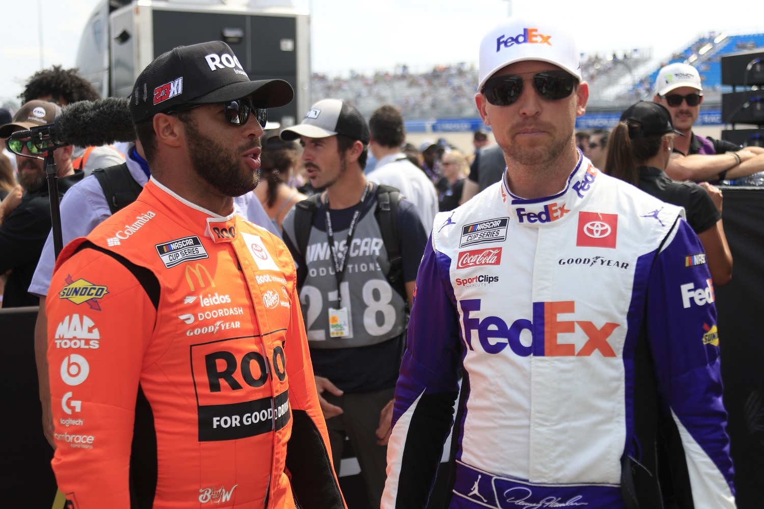 Bubba Wallace talks with Denny Hamlin during driver introductions prior to the NASCAR Cup Series Ally 400 on June 26, 2022, at Nashville SuperSpeedway.