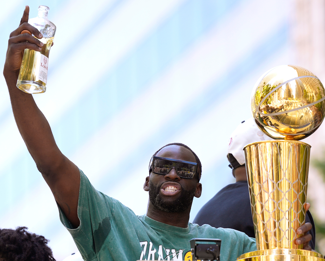 Draymond Green of the Golden State Warriors celebrates with the NBA Championship trophy.