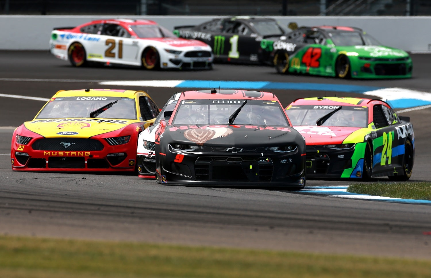 Chase Elliott, Joey Logano, and William Byron race during the NASCAR Cup Series Verizon 200 at the Brickyard at Indianapolis Motor Speedway on Aug. 15, 2021.