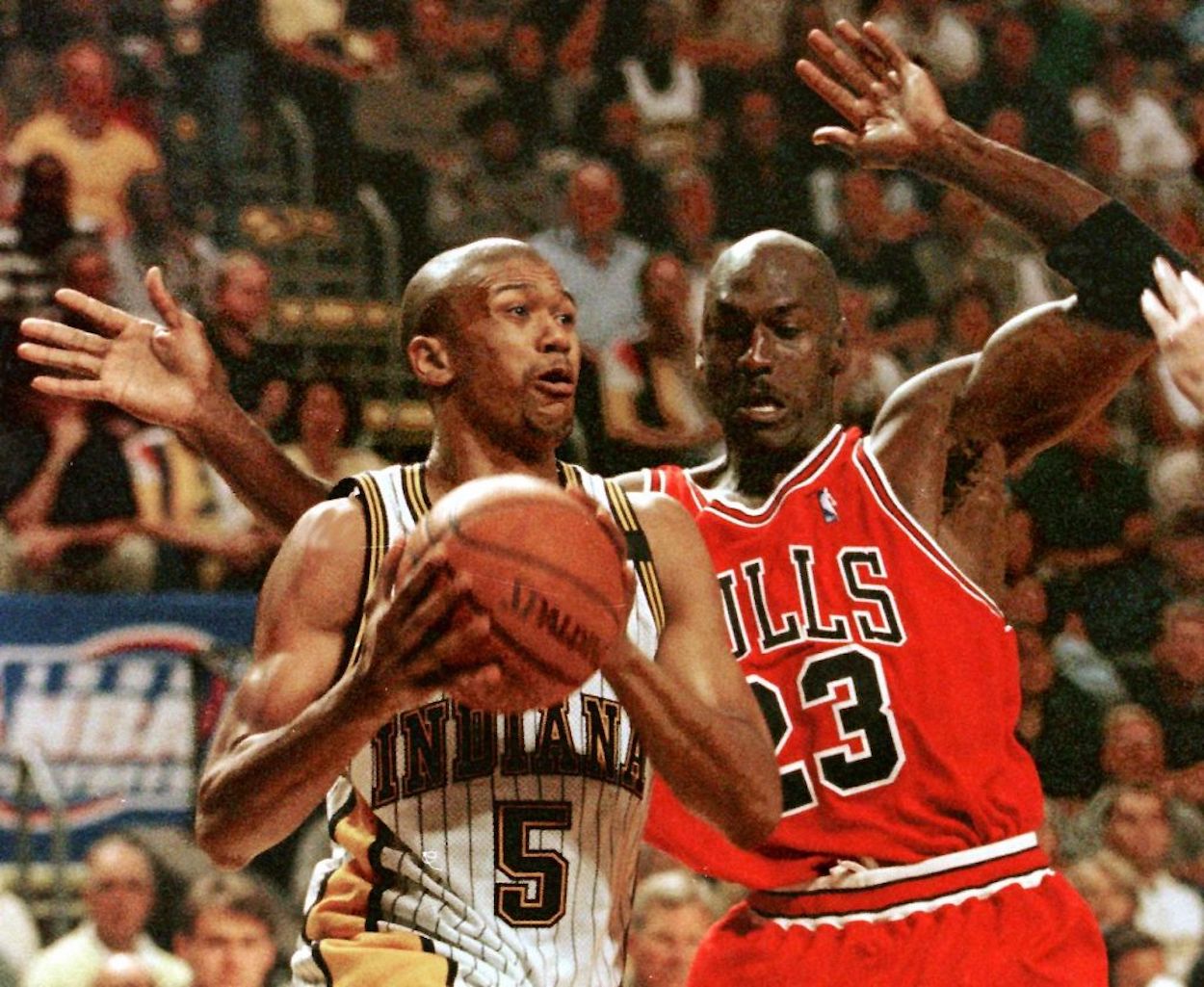 Jalen Rose (L) is defended by Michael Jordan (R) during an NBA game.