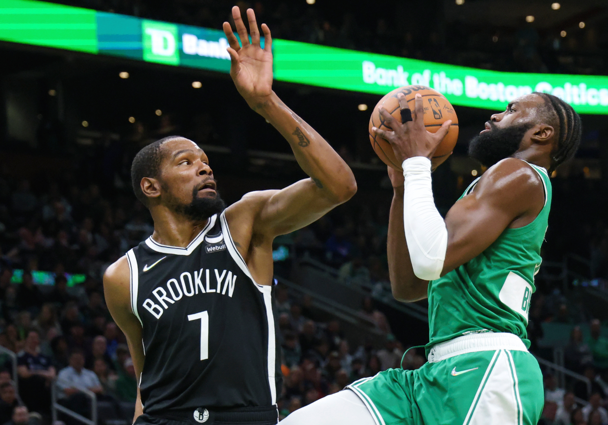 Boston Celtics guard Jaylen Brown drives to the basket with defensive pressure from Brooklyn Nets forward Kevin Durant.