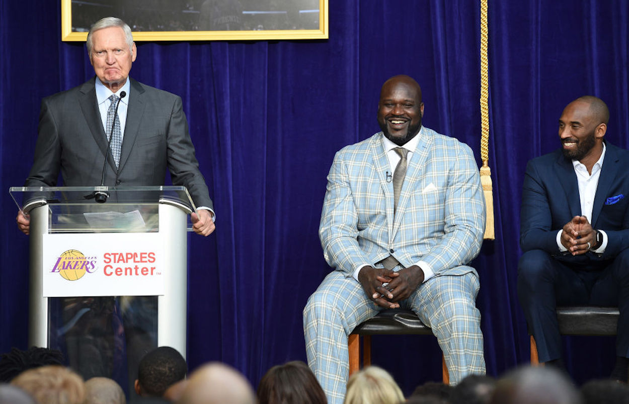 Jerry West (L) speaks as Shaquille O'Neal (C) and Kobe Bryant (R) look on.