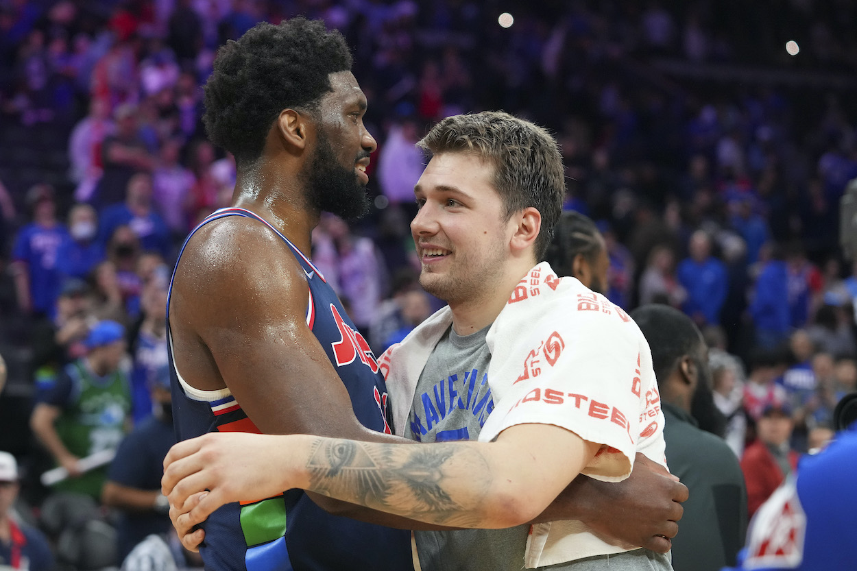 Joel Embiid and Luka Doncic embrace.