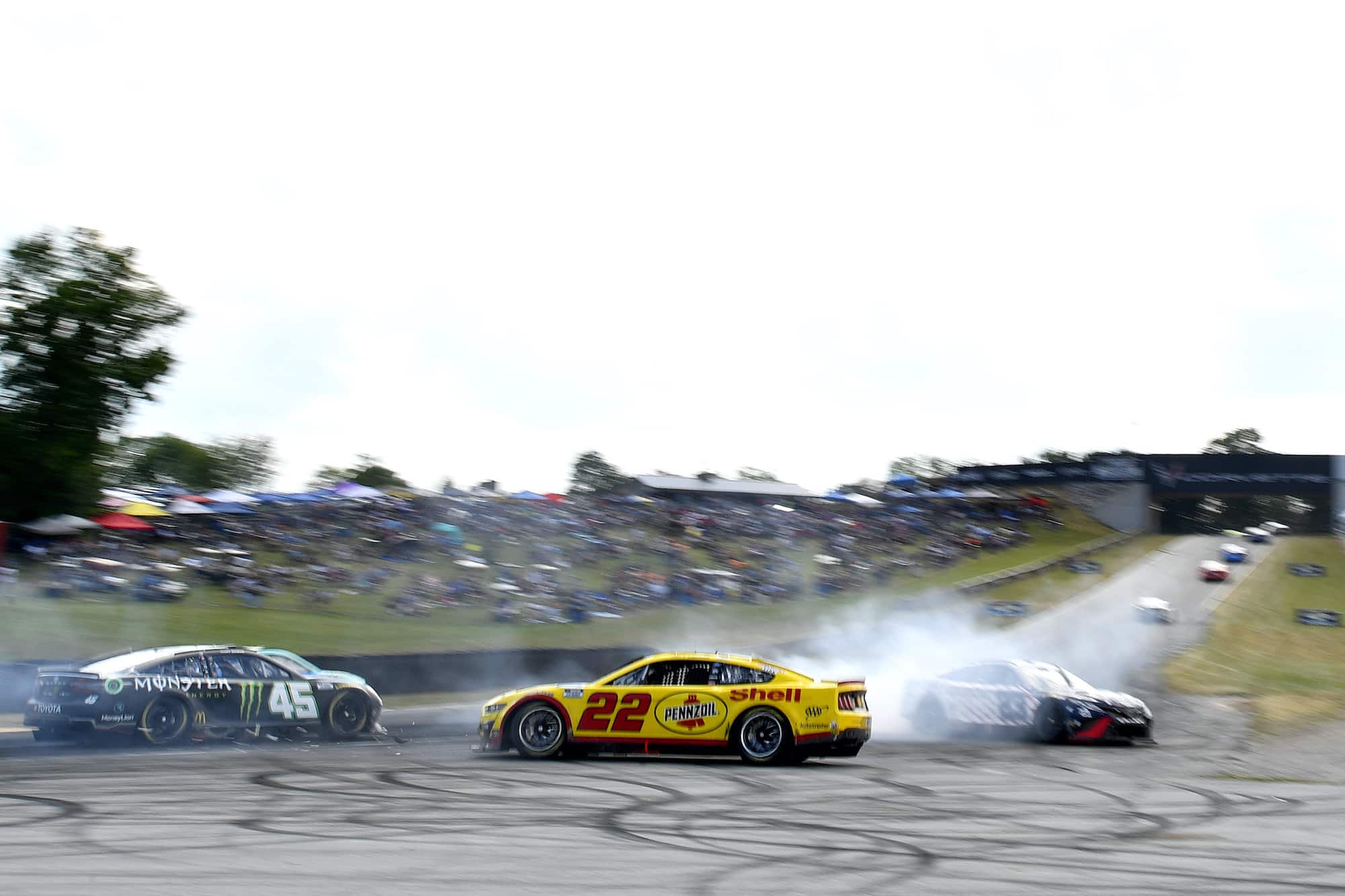 Joey Logano, Kurt Busch, and Bubba Wallace spin