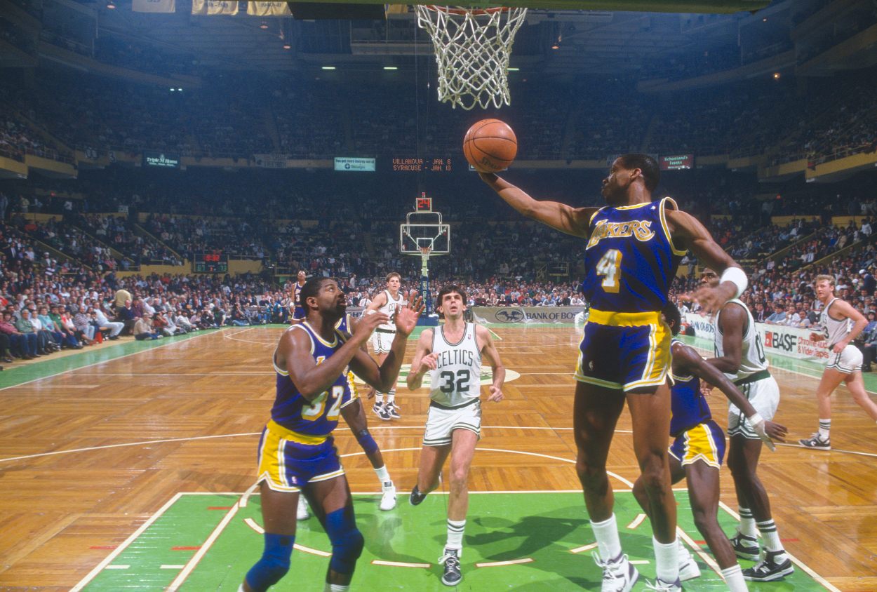 Byron Scott #4 of the Los Angeles Lakers grabs a rebound against the Boston Celtics.