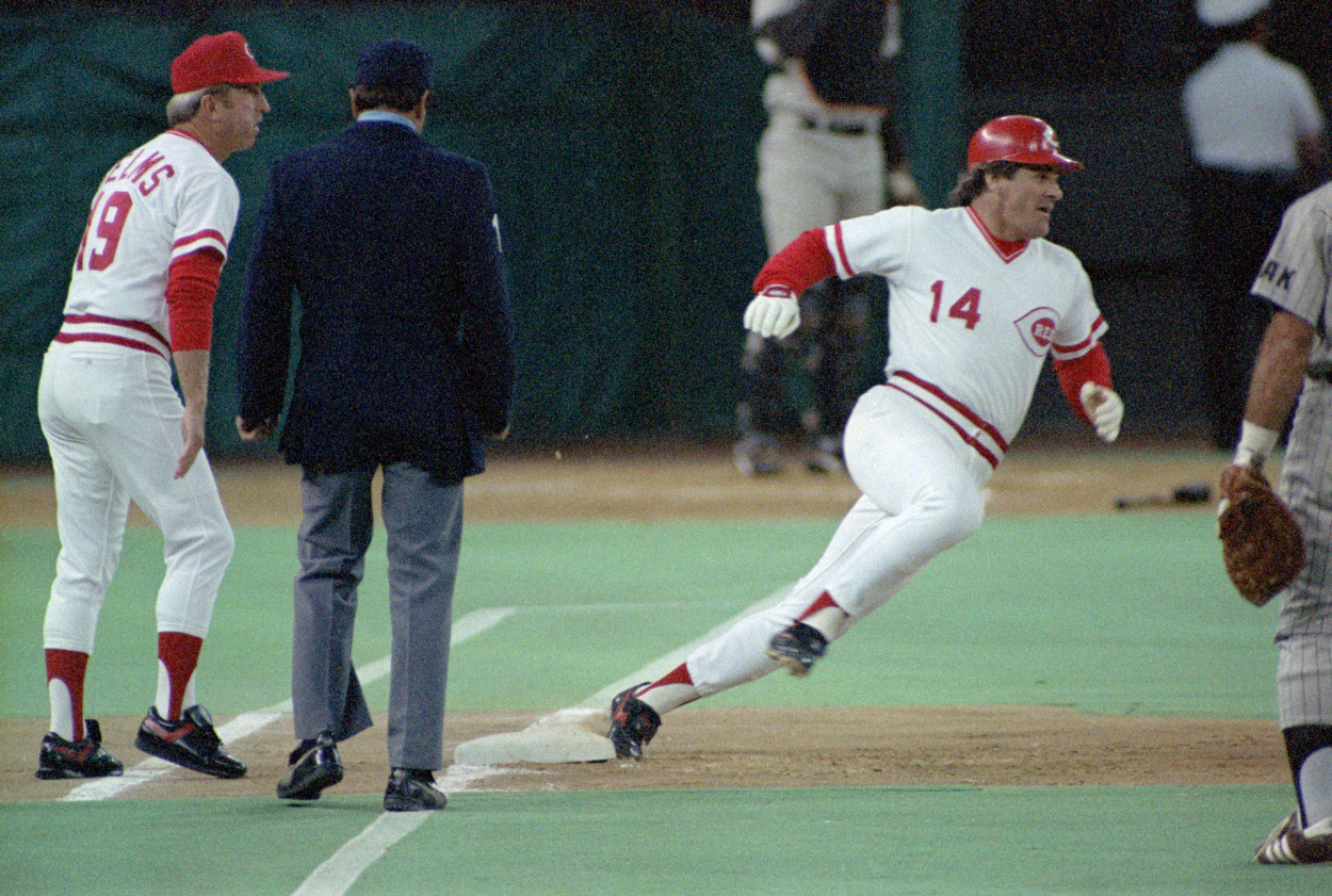 Pete Rose rounds first base during a game in 1985.