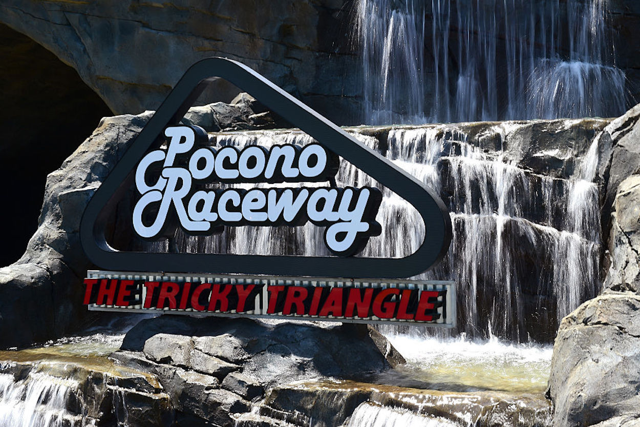 An entrance sign and water feature outside of Pocono Raceway.