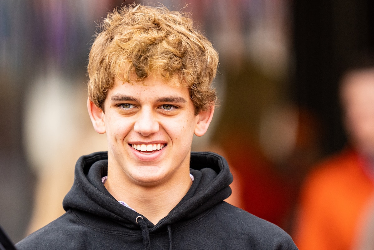 Arch Manning looks at the football field during his recruiting visit to Clemson University in 2021