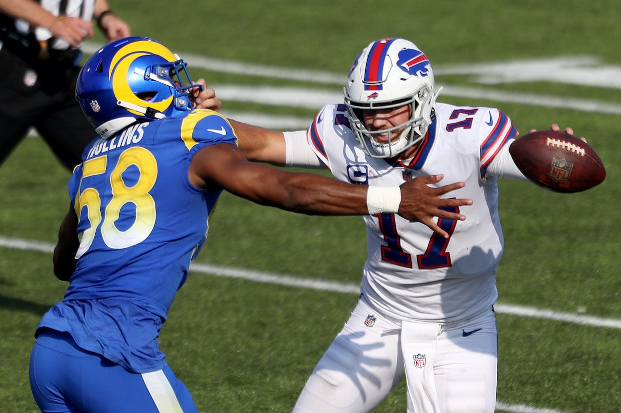 Justin Hollins attempts to tackle Josh Allen.