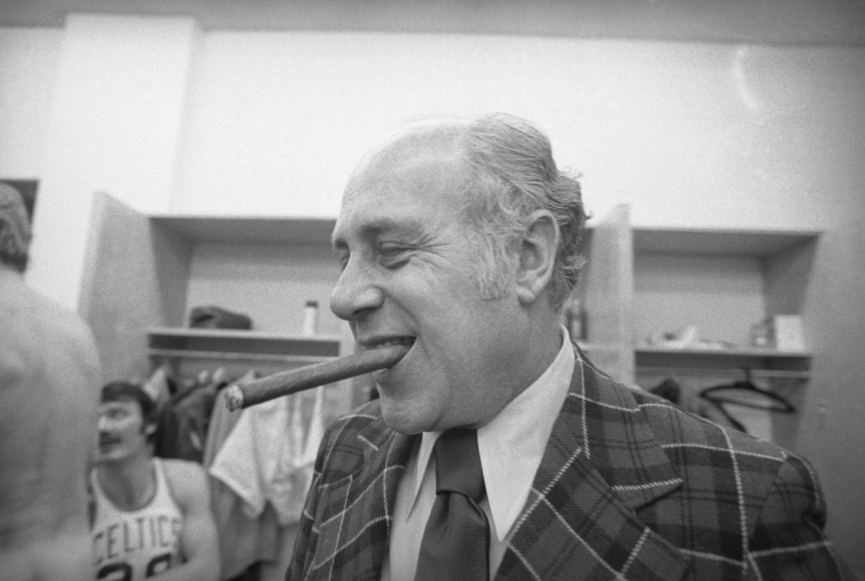 Arnold "Red" Auerbach, General Manager of the Boston Celtics, smokes his victory cigar.