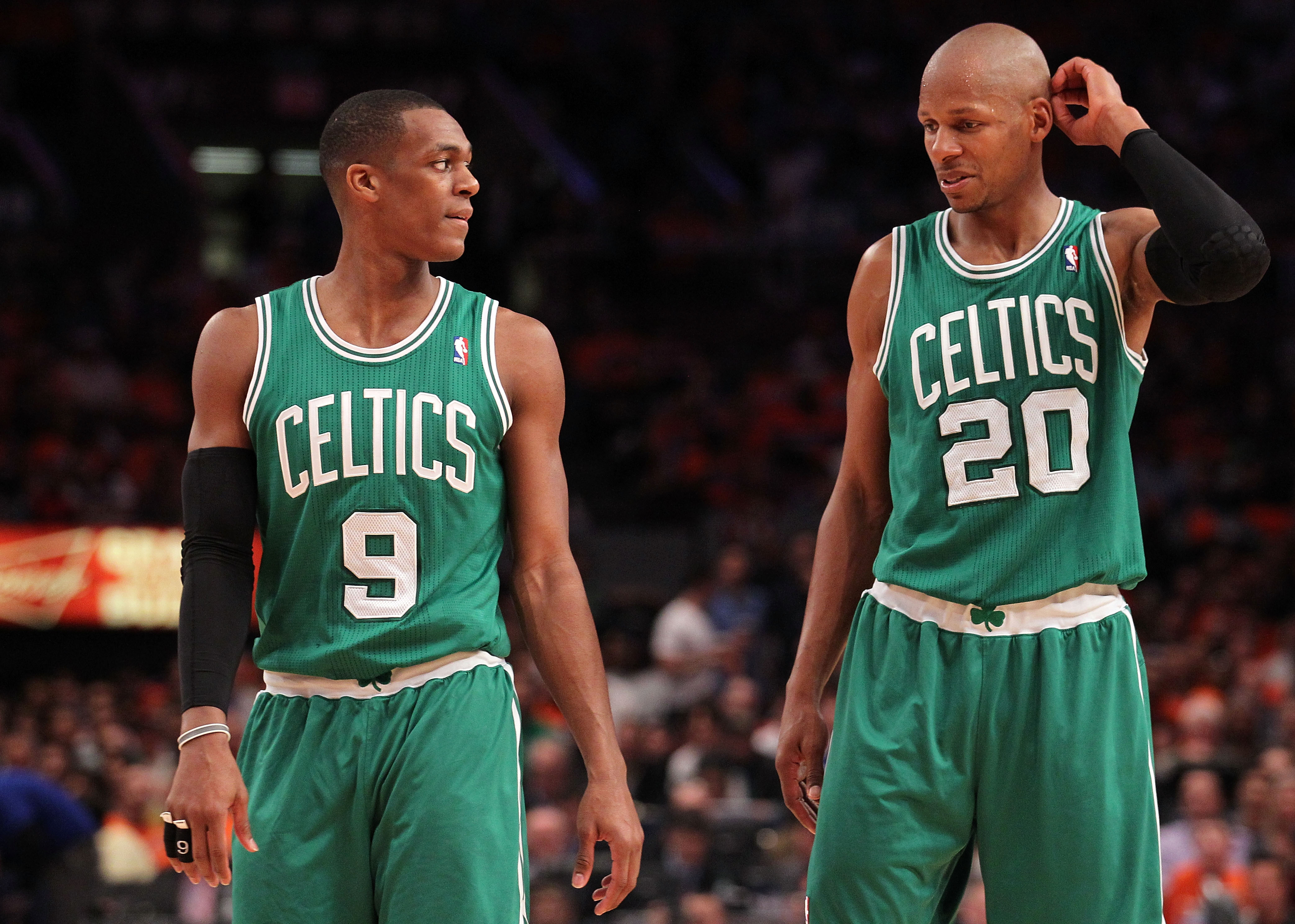 (L-R) Rajon Rondo and Ray Allen of the Boston Celtics talk on court.