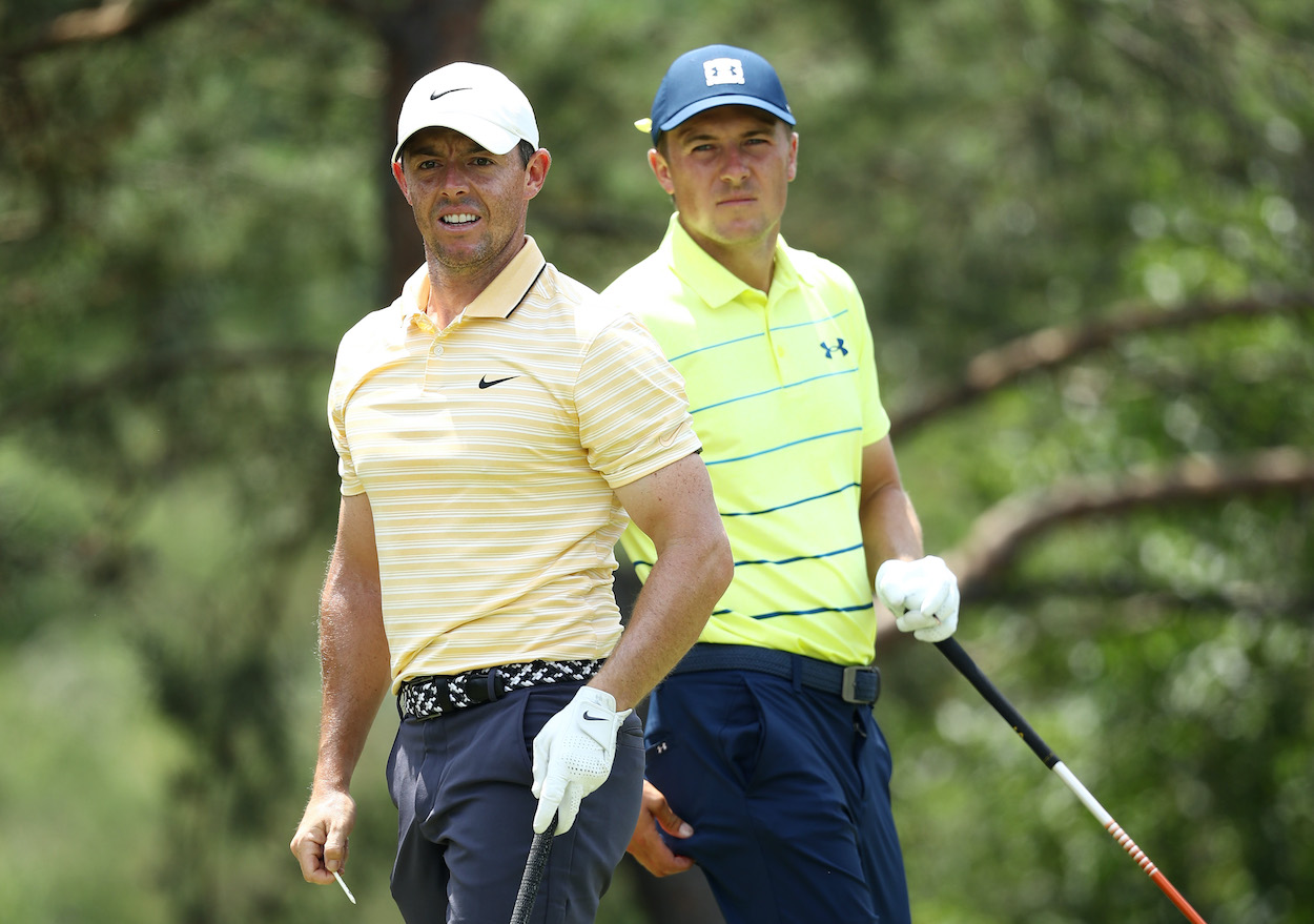 Rory McIlroy and Jordan Spieth look on from the tee.