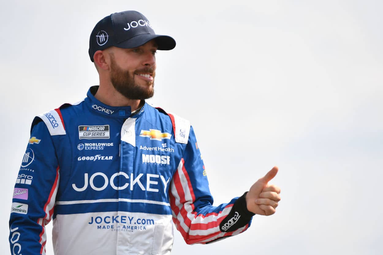 Ross Chastain gives a thumbs up ahead of a NASCAR race.