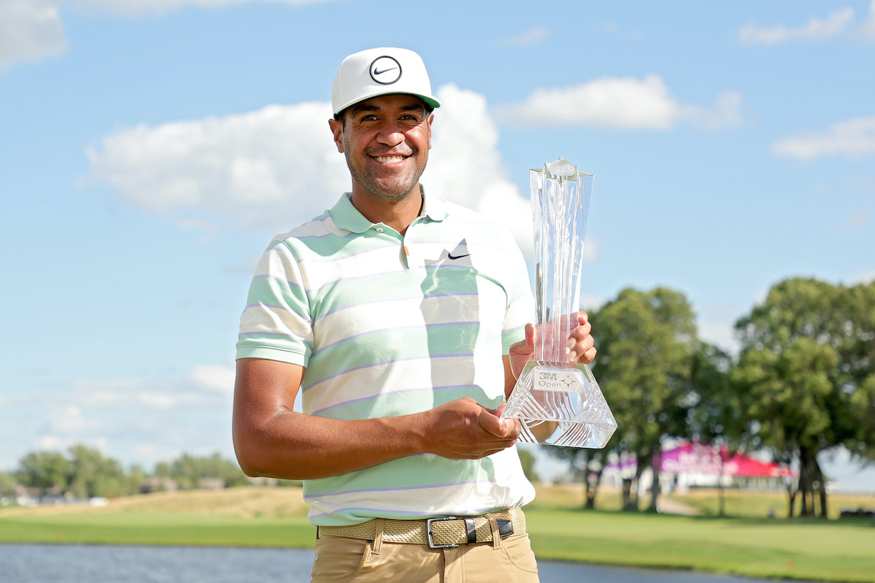 Tony Finau holds the trophy after winning the 3M Open.