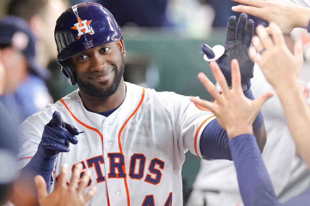 Yordan Alvarez high-fives his Houston Astros teammates after a home run.