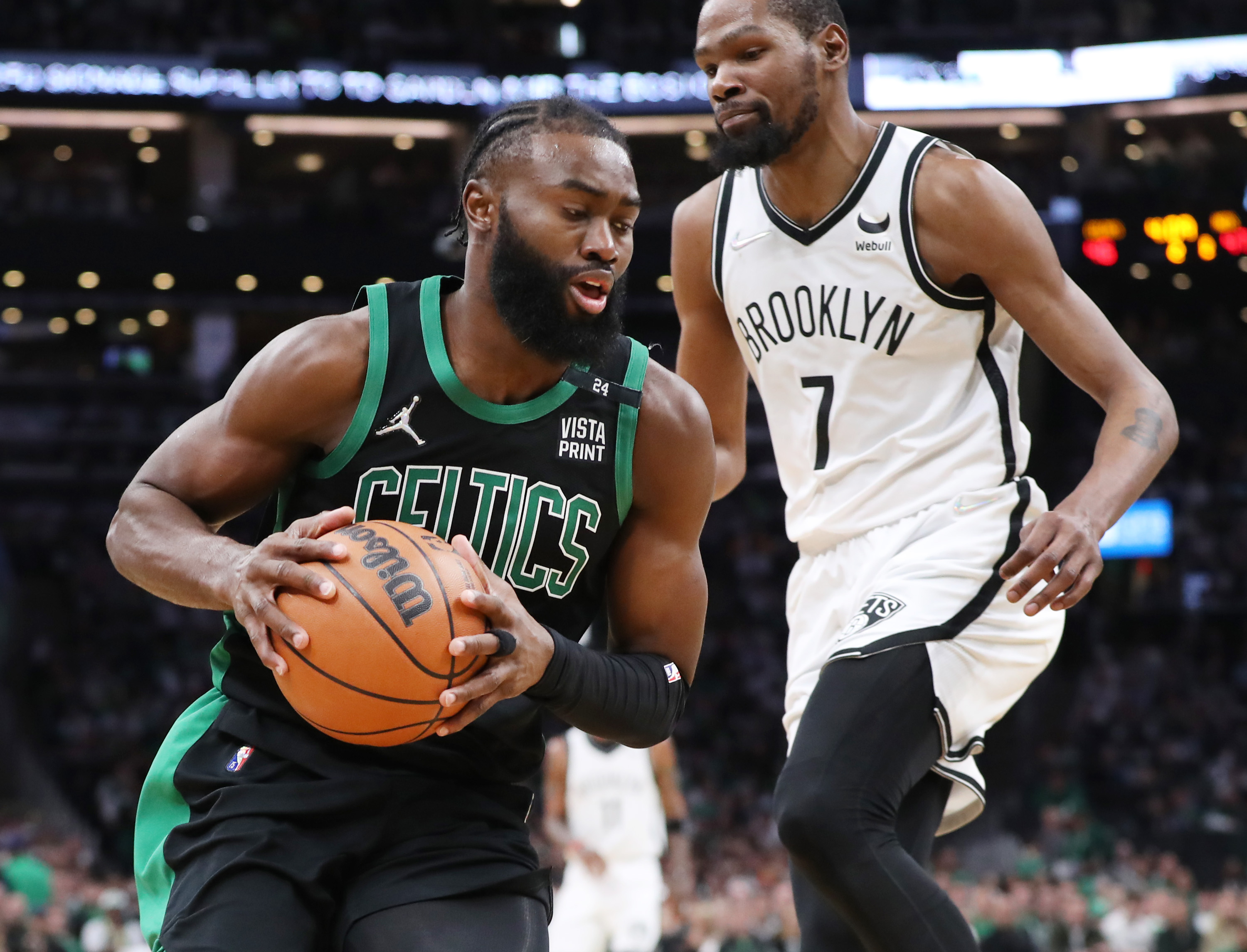 Boston Celtics guard Jaylen Brown grabs a rebound defended by Brooklyn Nets forward Kevin Durant.