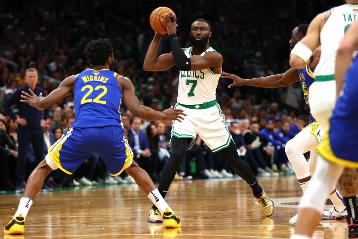 Jaylen Brown of the Boston Celtics is defended by Andrew Wiggins of the Golden State Warriors.
