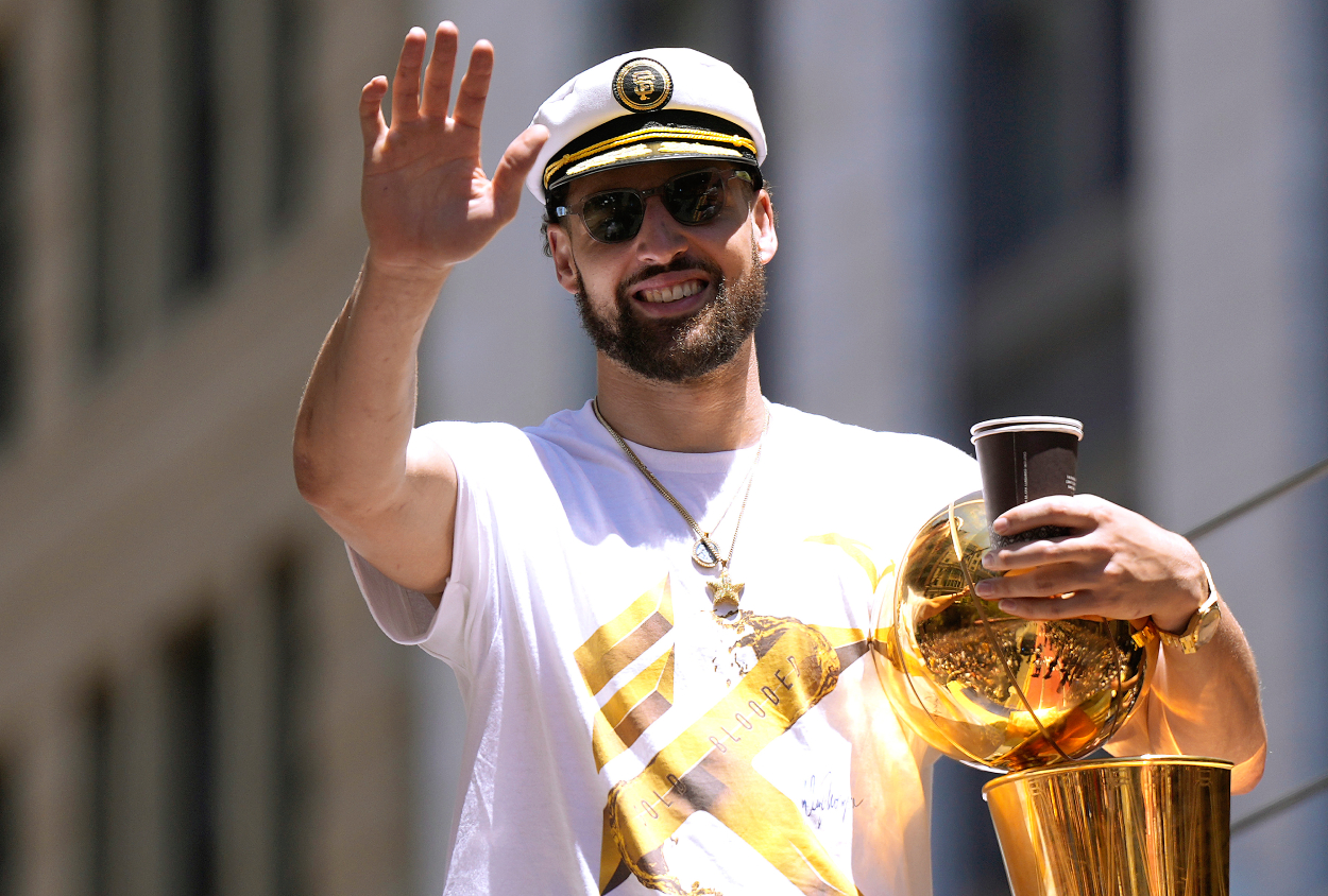 Klay Thompson of the Golden State Warriors celebrates with the NBA Championship Trophy.