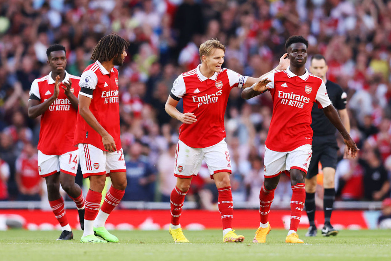 Arsenal players celebrate a goal during a win over Fulham.