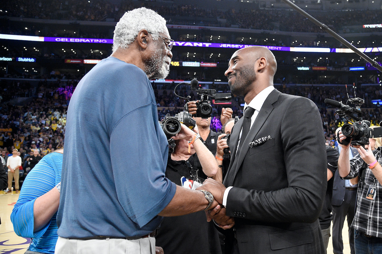 Bill Russell shakes hands with Kobe Bryant.