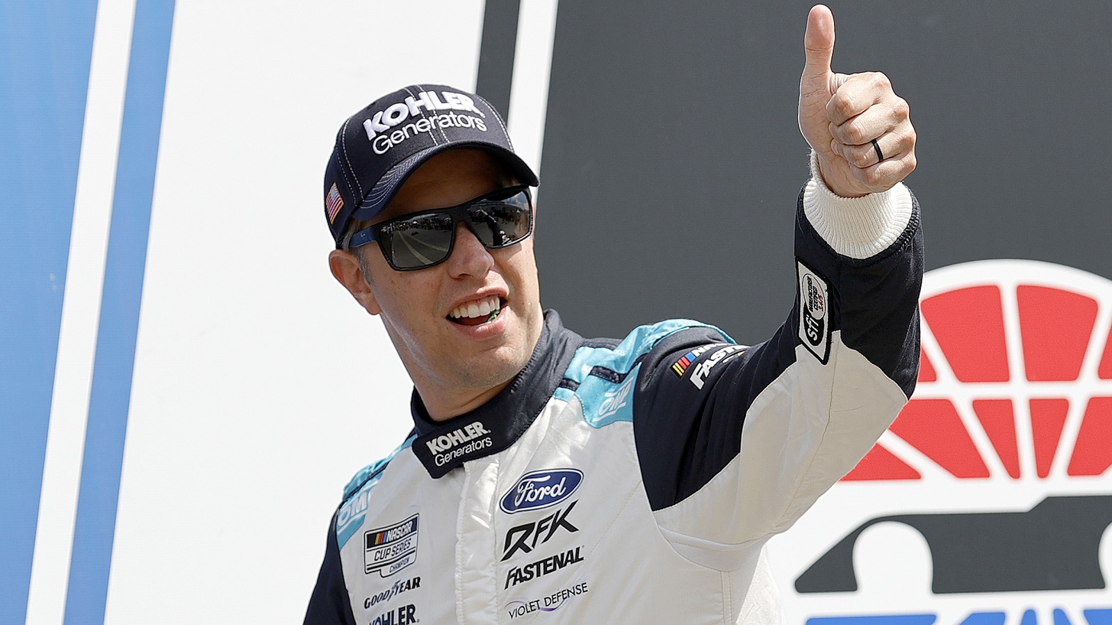 Brad Keselowski gives a thumbs up to fans during driver intros prior to the NASCAR Cup Series Ambetter 301 at New Hampshire Motor Speedway on July 17, 2022.