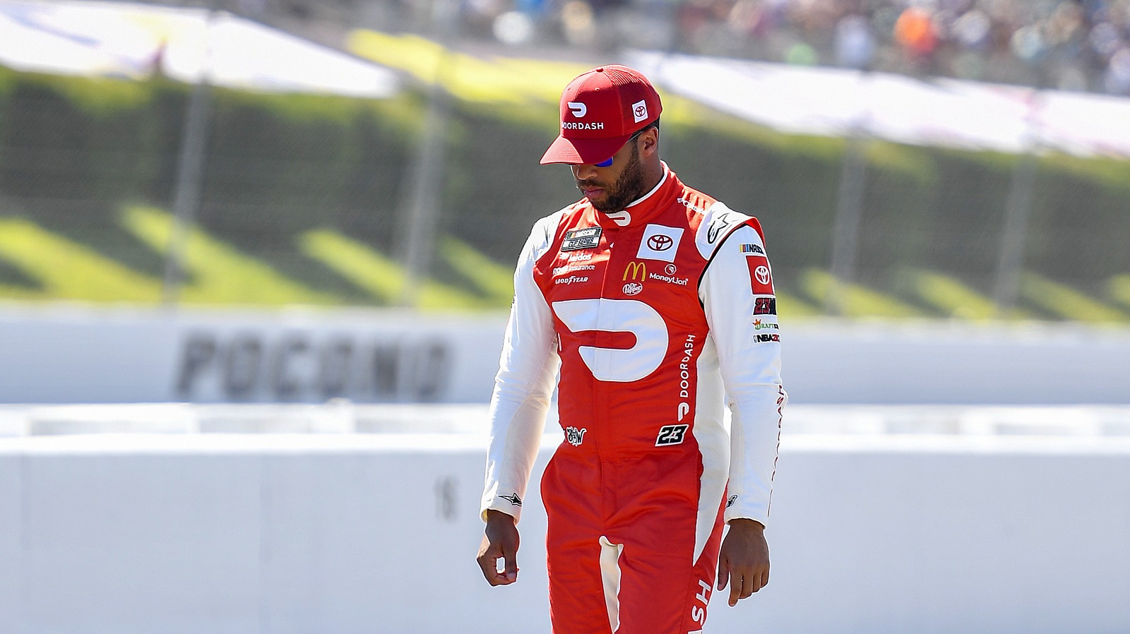 Bubba Wallace walks the grid during qualifying for the NASCAR Cup Series M&M's Fan Appreciation 400 at Pocono Raceway on July 23, 2022.
