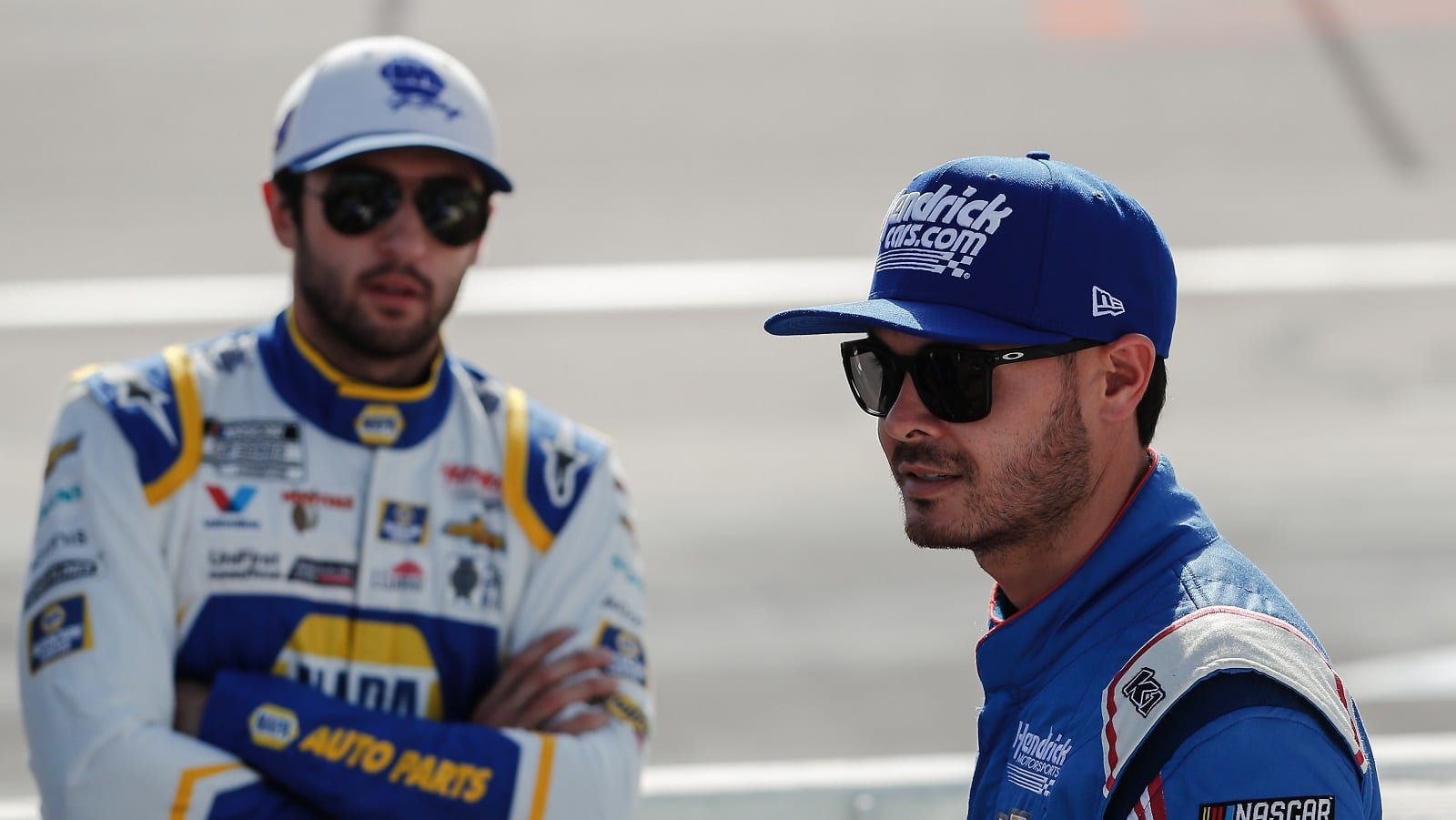 Kyle Larson walks in front of Hendrick Motorsports teammate Chase Elliott before the NASCAR Cup Series Championship 4 on Nov. 7, 2021, at Phoenix Raceway.