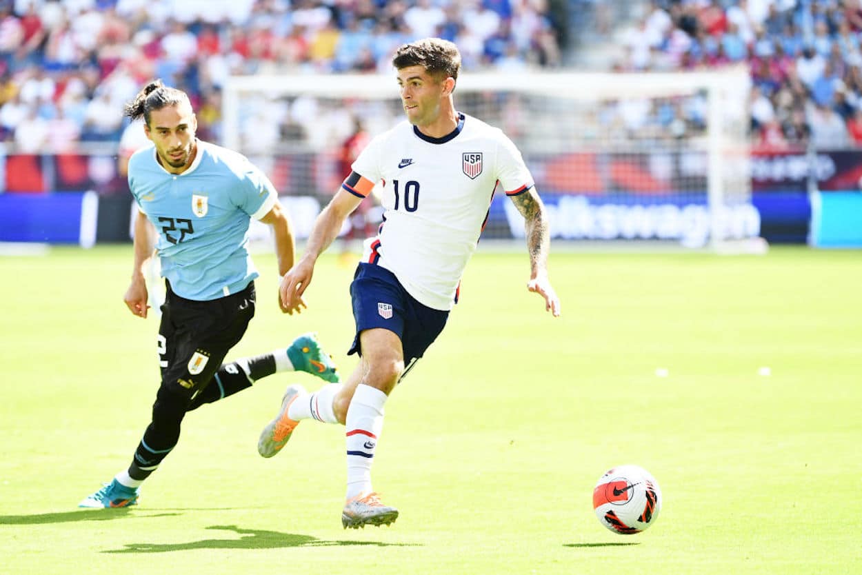 Christian Pulisic dribbles the ball for the United States Men's National Team.