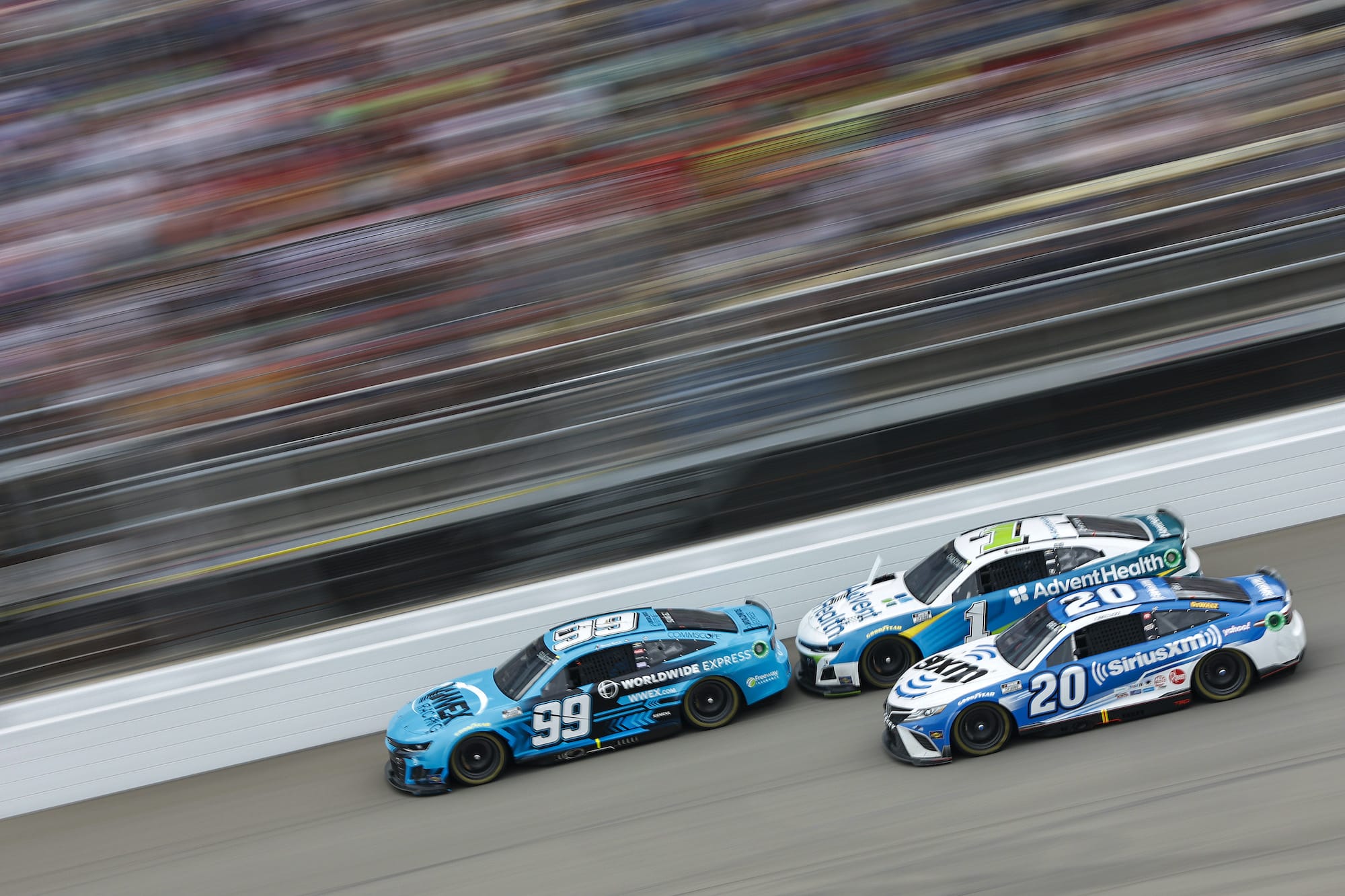 Christopher Bell, Ross Chastain and Daniel Suarez race