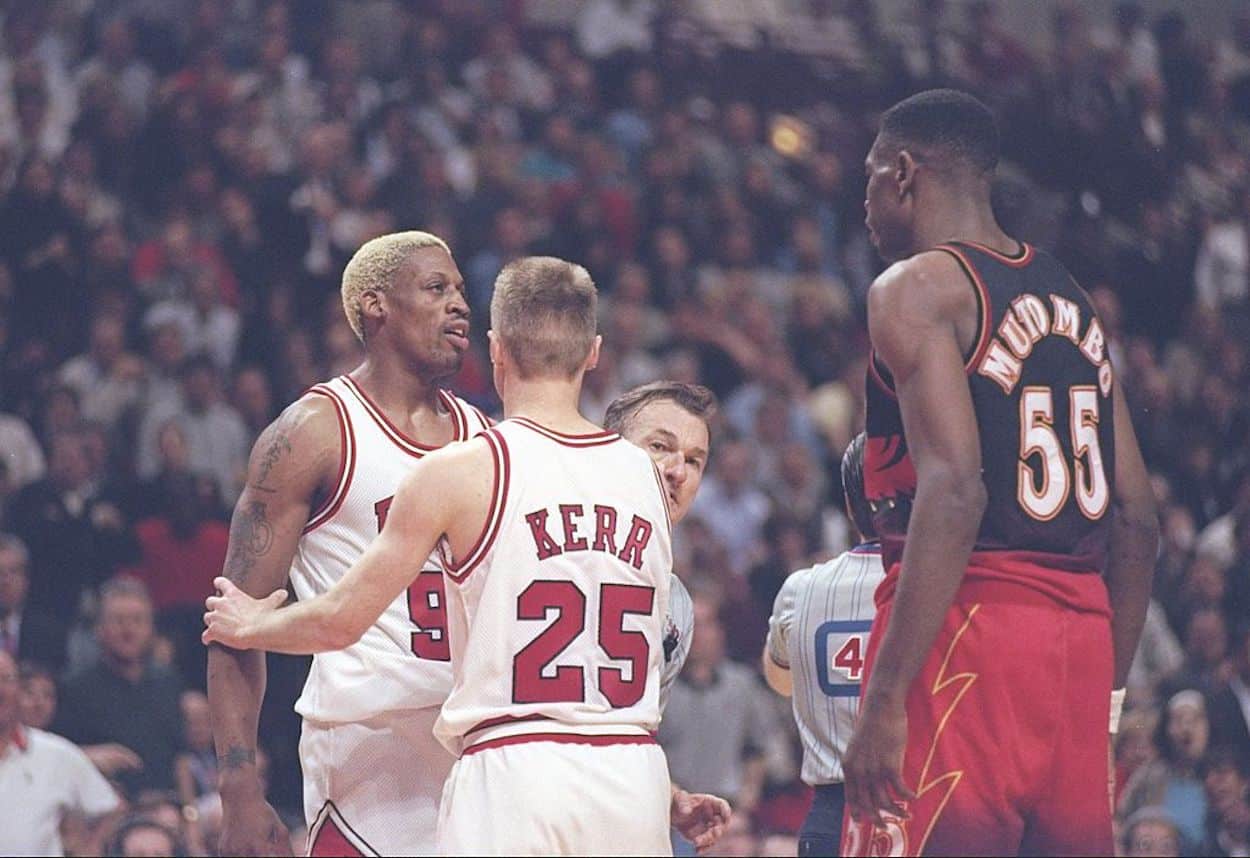 Dennis Rodman (L) stares down Dikembe Mutombo (R) as Steve Kerr (C) separates the men.