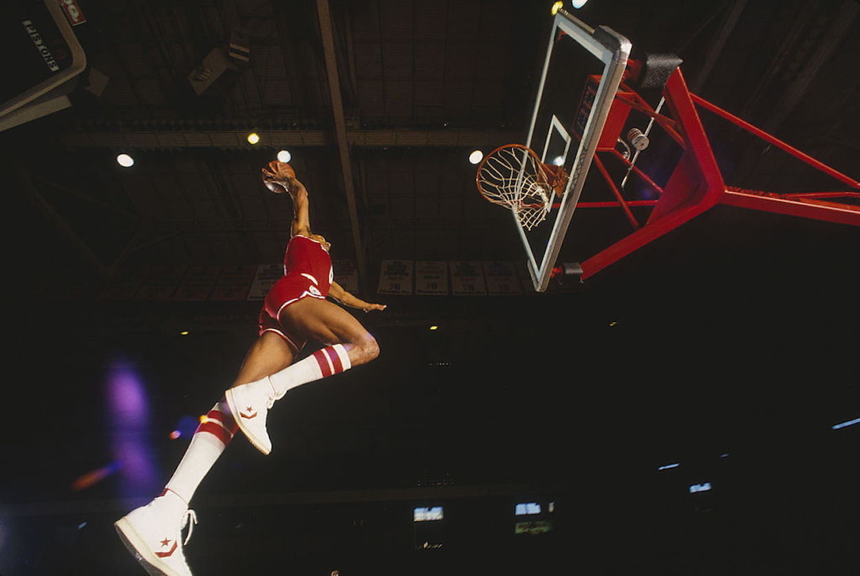 Julius Erving, popularly known as Dr. J, dunks a basketball