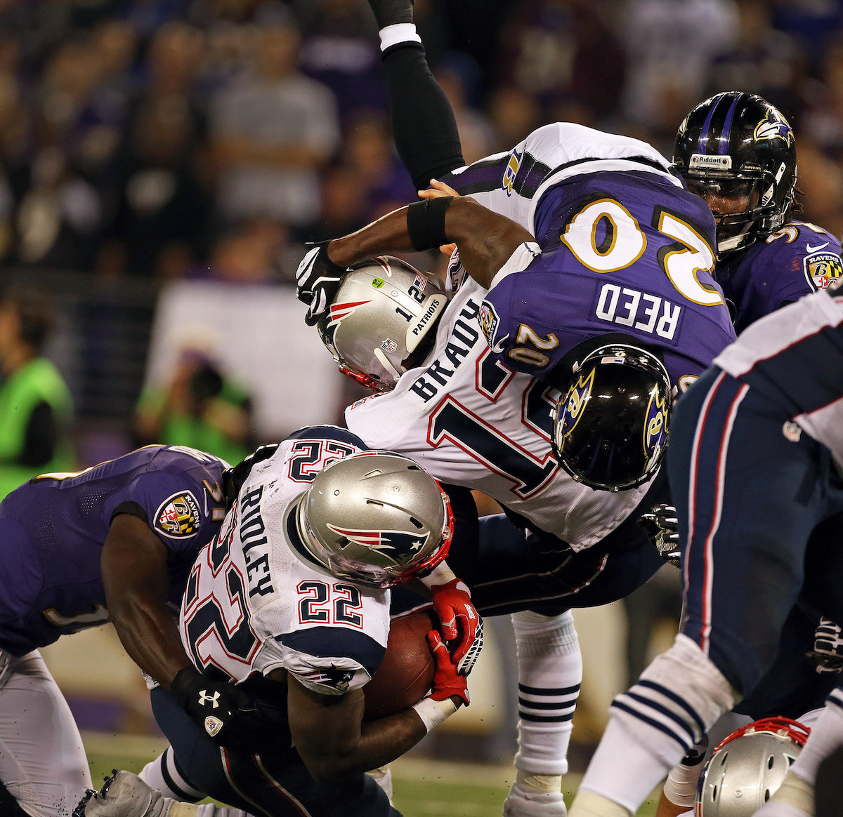 The Ravens Ed Reed sails over Patriots quarterback Tom Brady in 2012