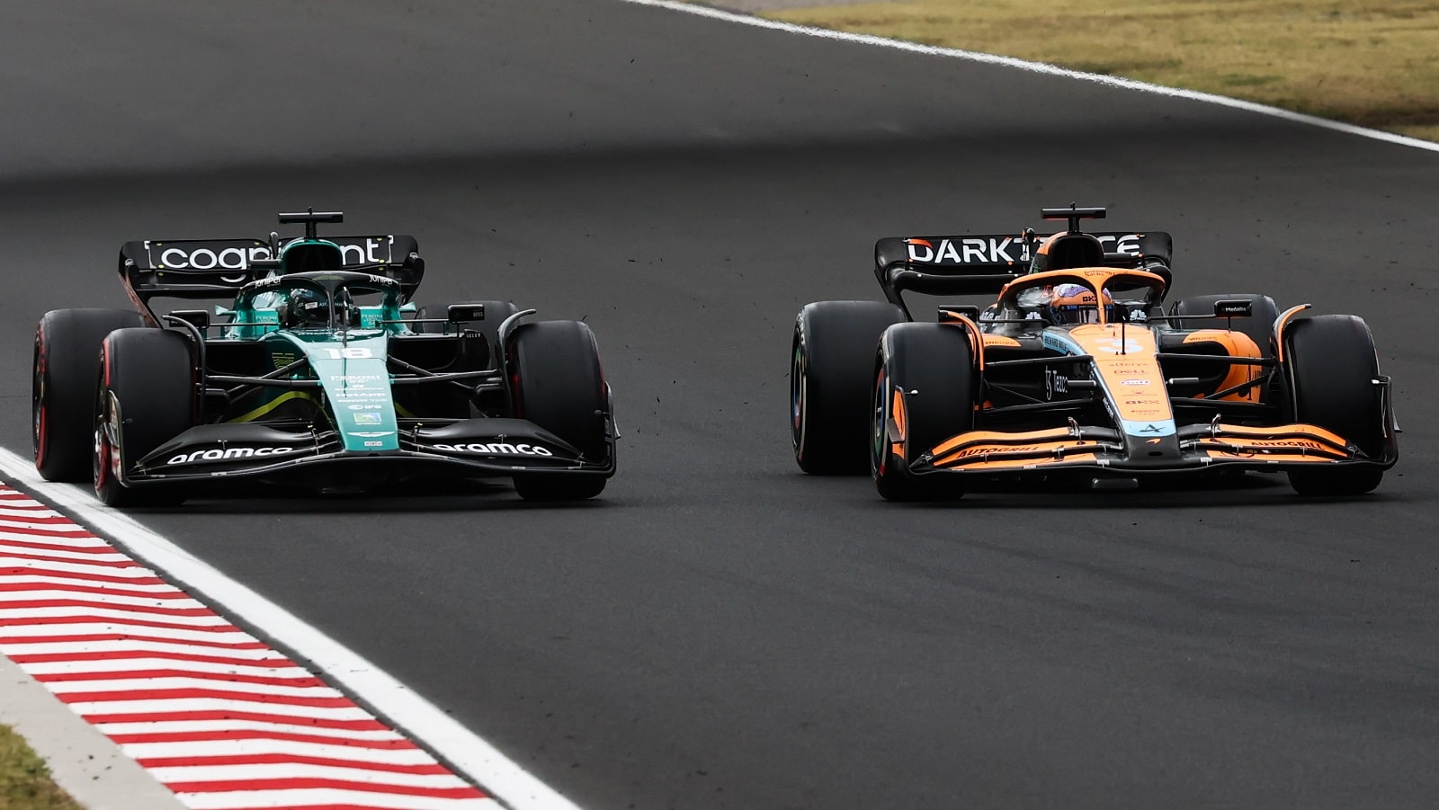 Lance Stroll of Aston Martin Aramco and Daniel Ricciardo of McLaren during the Formula 1 Hungarian Grand Prix at Hungaroring in Budapest, Hungary on July 31, 2022. | Jakub Porzycki/NurPhoto via Getty Images