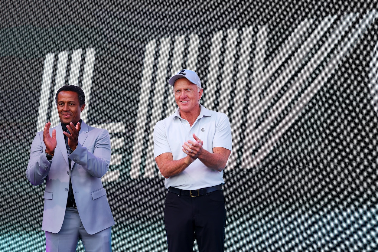 Greg Norman claps during an LIV Golf event.