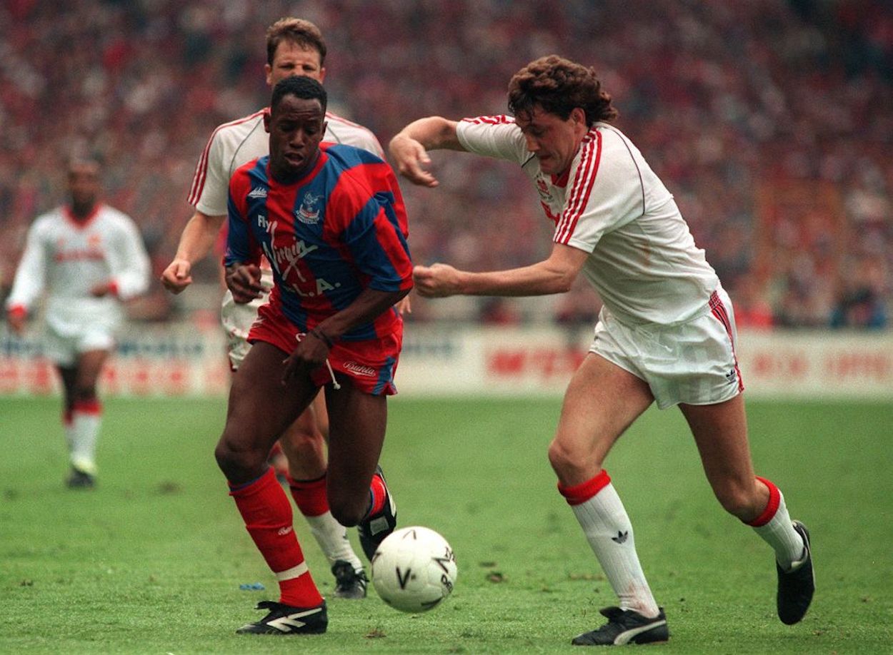 Crystal Palace forward Ian Wright dribbles the ball against Manchester United.