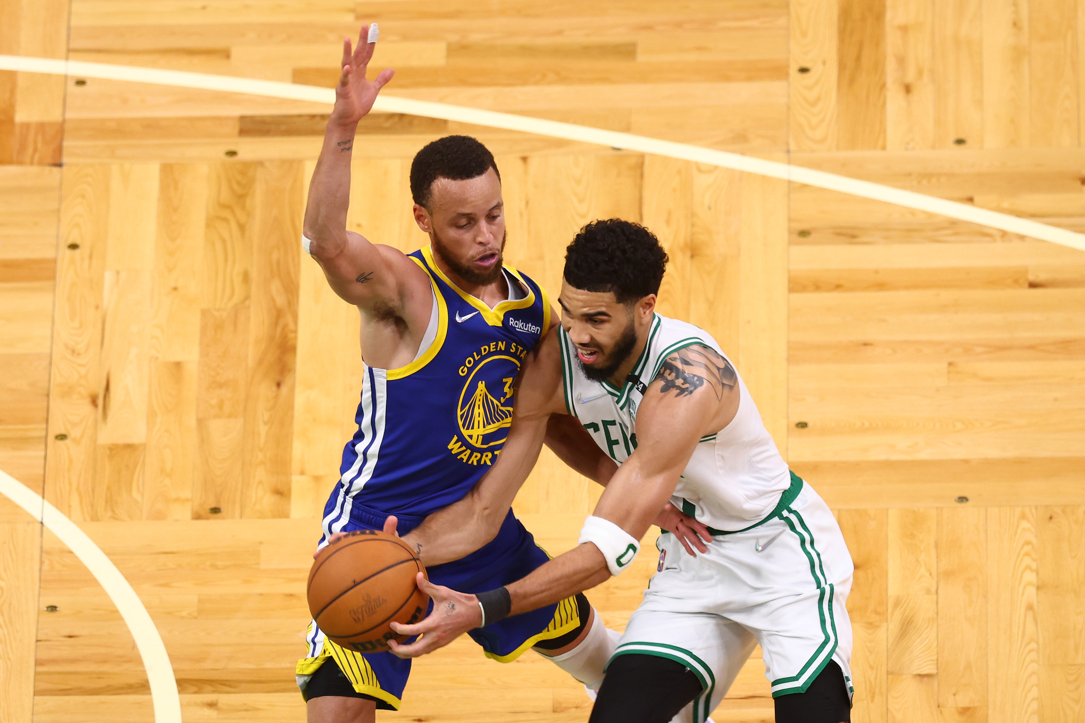 Jayson Tatum of the Boston Celtics is defended by Stephen Curry of the Golden State Warriors.