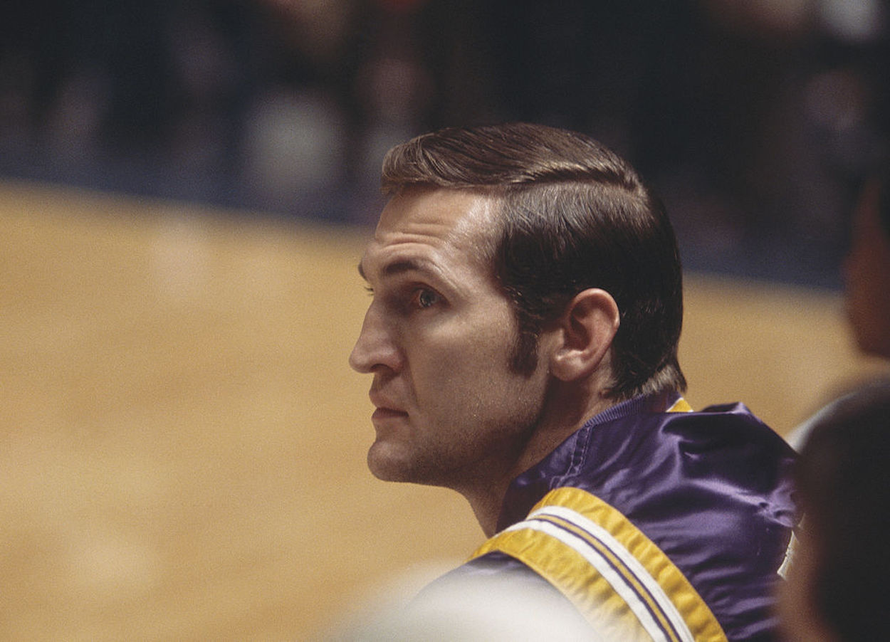 Los Angeles Lakers guard Jerry West sits on the bench.