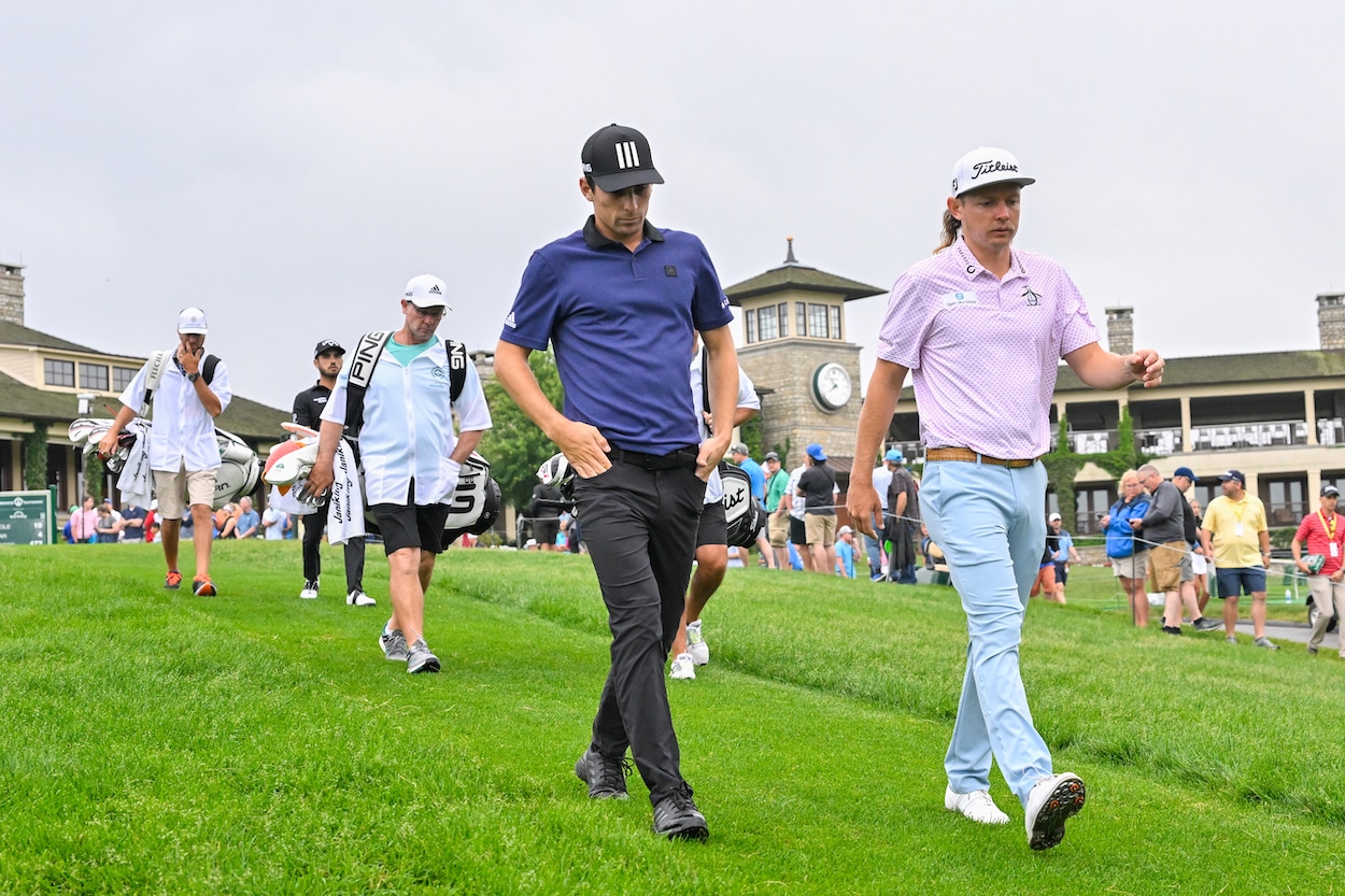 Joaquin Niemann and Cameron Smith walk off a tee box.