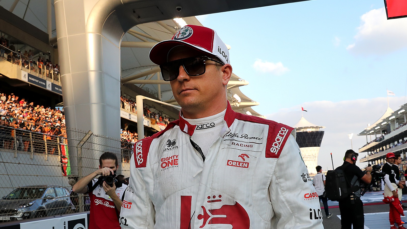 Kimi Raikkonen walks on the grid prior to the Formula 1 Grand Prix of Abu Dhabi at Yas Marina Circuit on Dec. 12, 2021.
