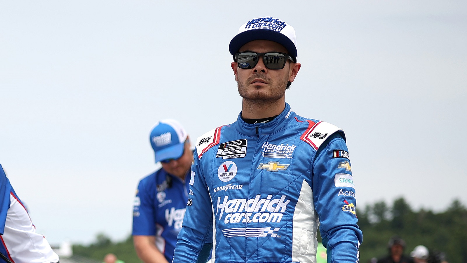 Kyle Larson walks the grid during qualifying for the NASCAR Cup Series Ambetter 301 at New Hampshire Motor Speedway on July 16, 2022.