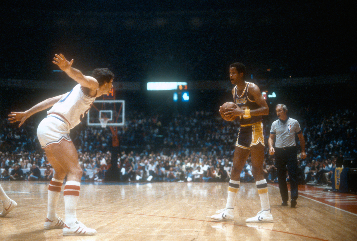 Jamaal Wilkes of the Los Angeles Lakers looks to put a move on Steve Mix of the Philadelphia 76ers.