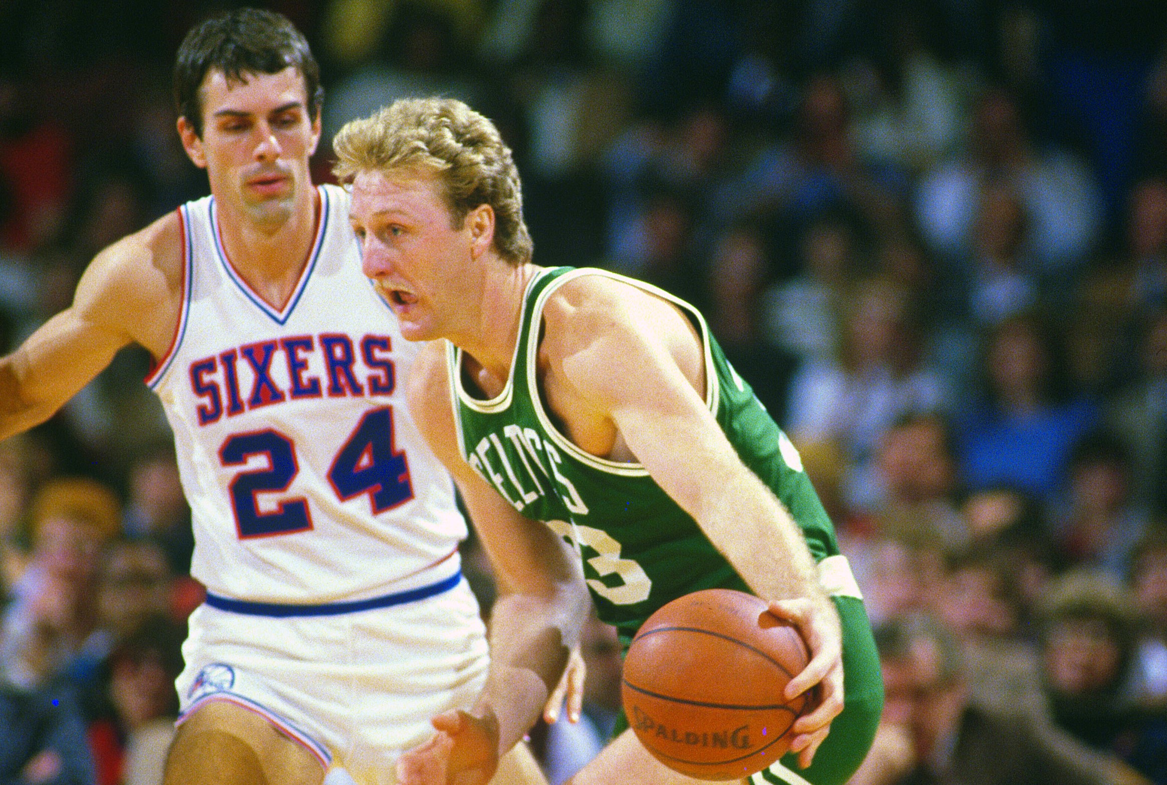 Larry Bird of the Boston Celtics looks to drive on Bobby Jones of the Philadelphia 76ers.
