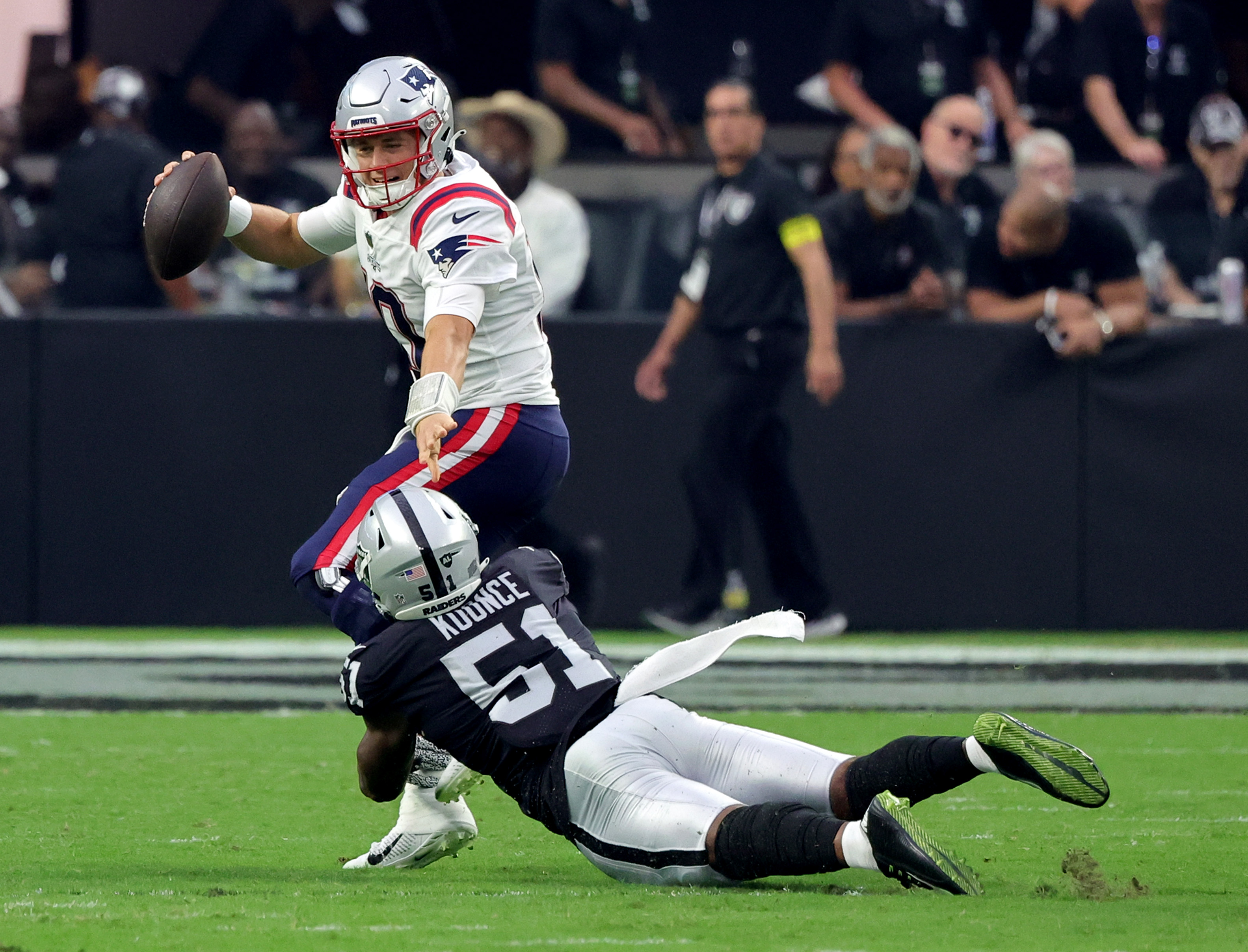 Defensive end Malcolm Koonce of the Las Vegas Raiders sacks quarterback Mac Jones of the New England Patriots.